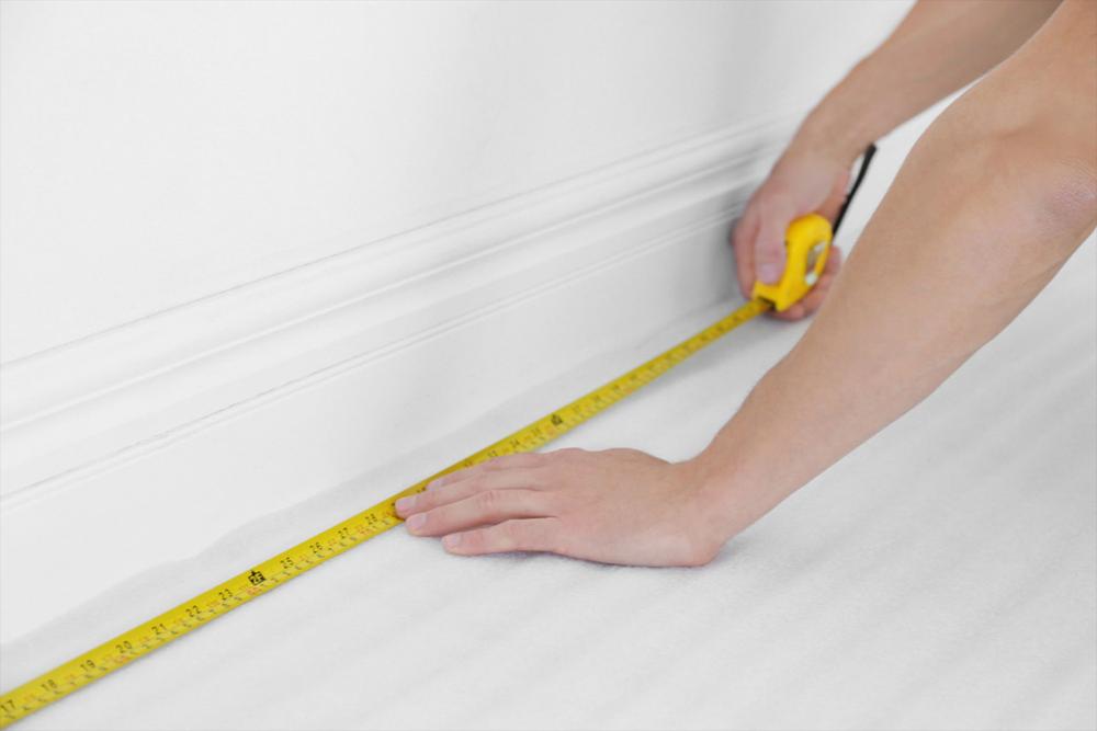 guy measuring the floor of the room