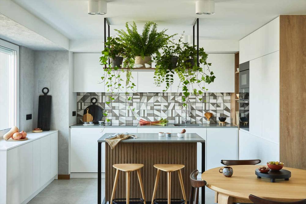 kitchen island placed under leaves hanging from ceiling